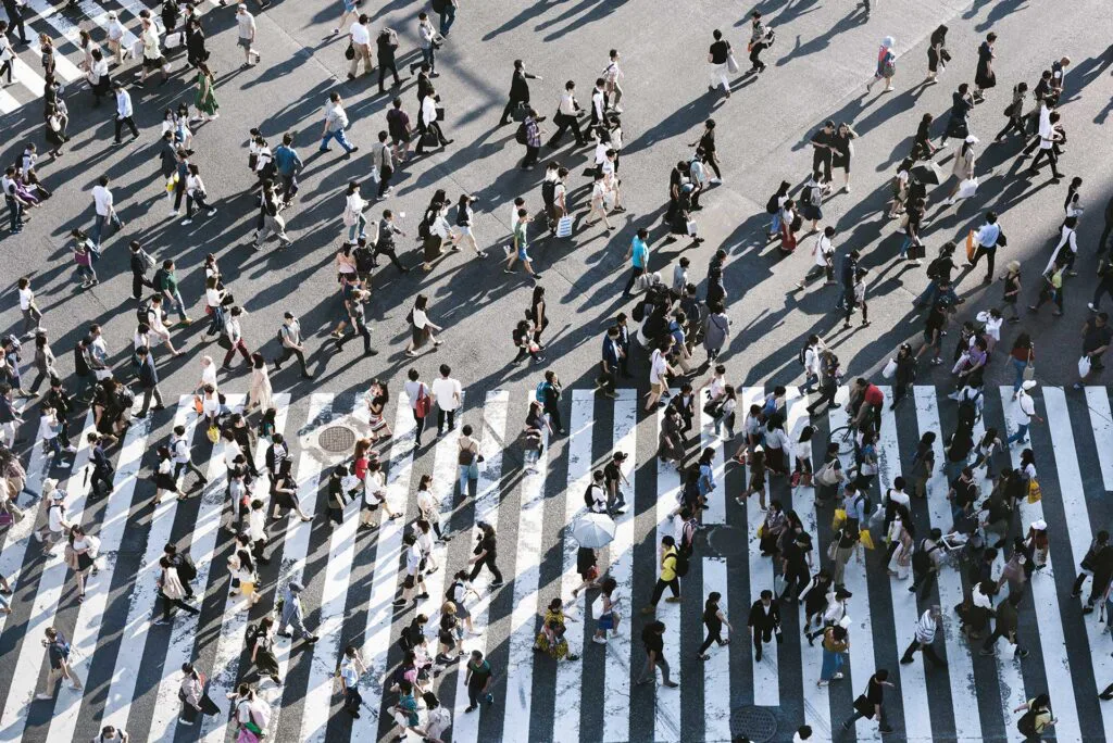 crowd of people crossing the street